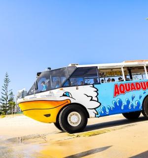 a bus parked on the beach next to a beach