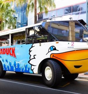 a bus with a boat painted on the side of the road