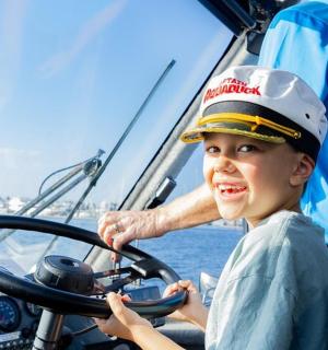 a young boy is sitting on a boat