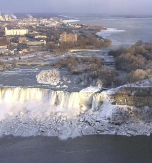 an aerial view of a waterfall in the water