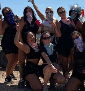 a group of women in costumes posing for a picture