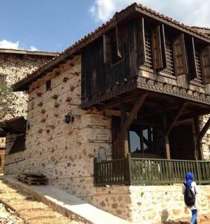 two people walking outside of a building with a balcony