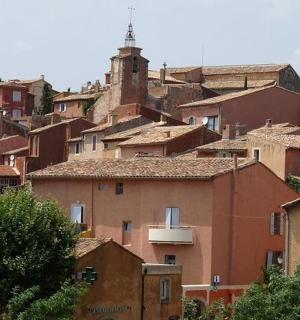 a group of houses in a town with a tower