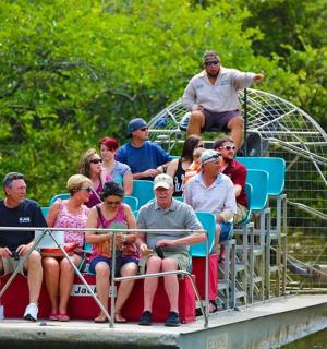 a group of people sitting on a boat on the water
