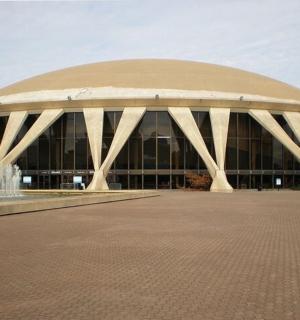 a large building with a fountain in front of it