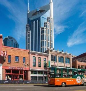 a bus driving down a city street with tall buildings