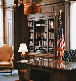 an office with a desk and an american flag