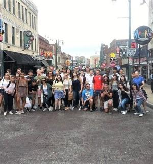 a group of people standing in the middle of a street