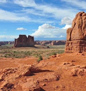 a view of the desert with a rock formation