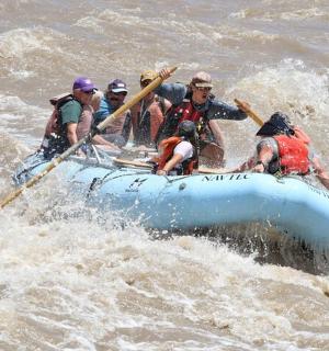 a group of people in a raft in the water