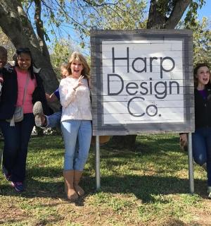 a group of people standing next to a sign