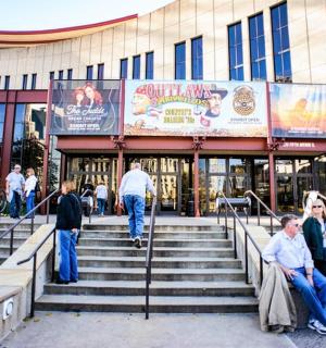 a group of people sitting on stairs in front of a building