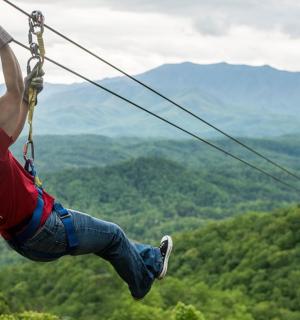 a man on a zip line in