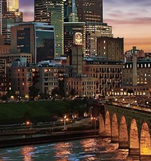 a city skyline with a bridge over a river