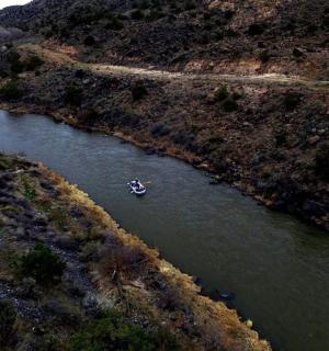an aerial view of a boat in a river