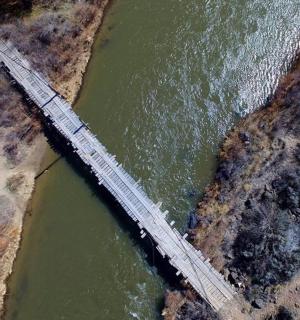 an overhead view of a bridge over a river