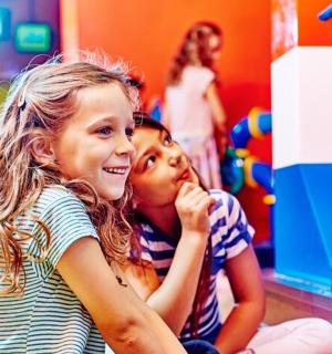 two young girls playing in a toy store