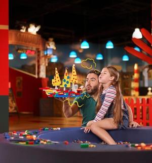 a man and a woman sitting in front of a birthday cake