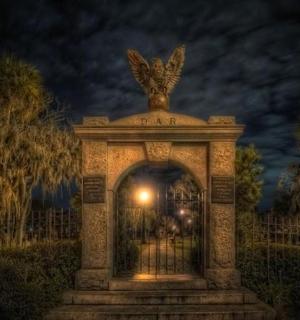 a gate with a bird on top of it