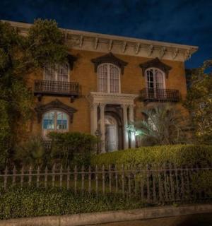 a large house with a fence in front of it