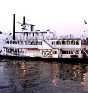 a ferry boat on the water with a bridge in the background