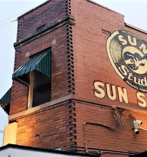 a brick building with a sun studio sign on it