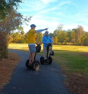 two people riding on segifts on a path
