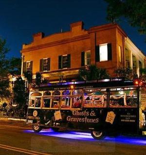 a bus driving down a street in front of a building