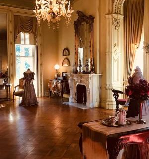 a large room with a fireplace and a table in it