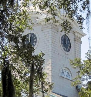 a tall white clock tower with a clock on it