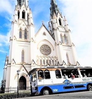 a bus is parked in front of a church