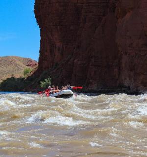 a group of people in a raft on a river