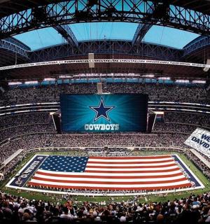 a crowd of people in an arena with an american flag
