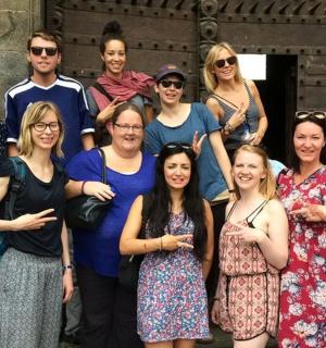 a group of people posing for a picture in front of a building