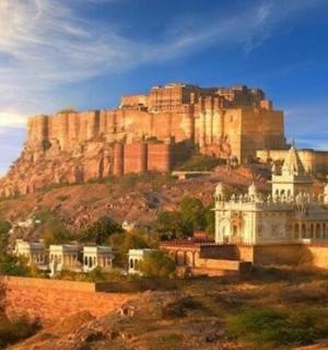 a building on a hill with a mountain in the background
