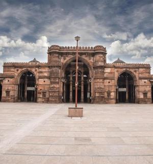 a large brick building with a pole in the middle