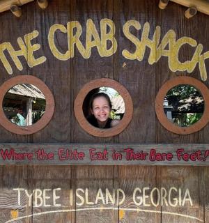 žena vystrkuje hlavu z chatrče na stromě