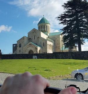 a person driving a car in front of a church