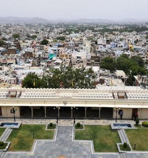 a large building with a city in the background