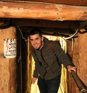 a man standing in a room with a pipe