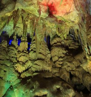 a view of a cave with blue lights in it