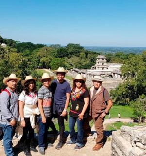 a group of people posing for a picture at a temple