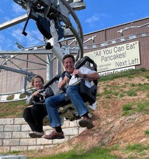 a man and a woman sitting on a ski lift