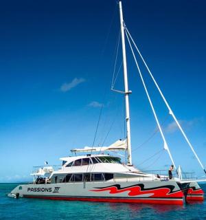 a boat sitting in the ocean on the water