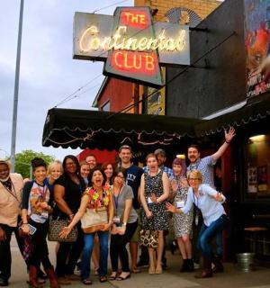 a group of people standing outside of a restaurant