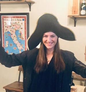 a woman wearing a mexican hat holding a bottle of beer