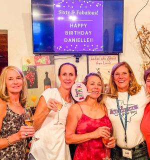 a group of women posing for a picture at a party