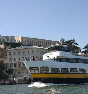 a large boat in the water near a building