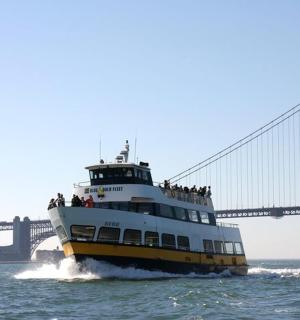 a boat in the water in front of a bridge