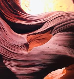 a rock formation in a canyon with the sun